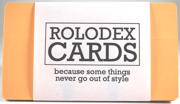 A bundle of 28 tiny Rolodex refill cards in orange, green, pink, and blue. They are wrapped with the orange on top. The label says, "ROLODEX CARDS: because some things never go out of style."