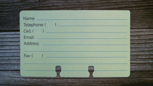 A pale yellow Rolodex contact card. There are spaces for Name, Telephone, Cell, Email, Address, and Fax