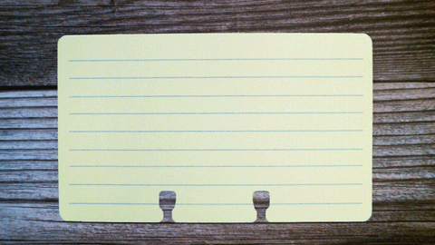A 3 x 5 lined Rolodex card in yellow with pale blue lines.