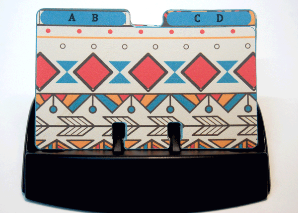 Colorful hand made Aztec Rolodex Dividers with two letters per divider: They are in a Black Rolodex with the AB and CD dividers visible. They are in a tribal print of tan, orange, red, blue and brown.