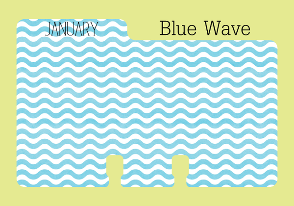 Rolodex refill divider calendar : The Rolodex divider is a wavy ocean blue and white stripe. The word JANUARY is printed on the tab in black capital letters. The divider is on a pale green background with the words "Blue Wave."