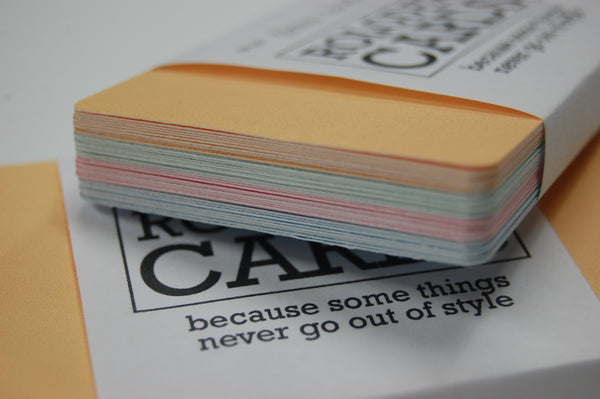 A bundle of 28 wrapped Mini Rolodex Refill Cards shown along the edge. The orange are on top followed by green, pink and blue.