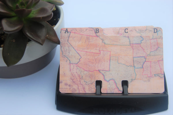 Mostly tan and brown Rolodex dividers in a black holder. The AB divider is on top.  It shows much of the southwest and south central United States. The states are in pale shades of blue and red, but the overall look is tan and brown.