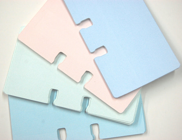 A fanned display of shabby chic Rolodex cards in pastel blue, green, pink, and purple