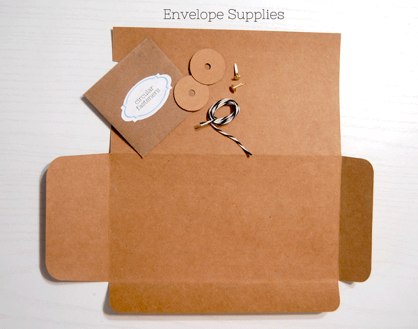 Envelope Kit Supplies: Kraft cardstock base, a kraft envelope with the words "circular fasteners" on it, two double thick kraft circles with holes in the center, two gold brads, 13 inches of black and white baker's twine.