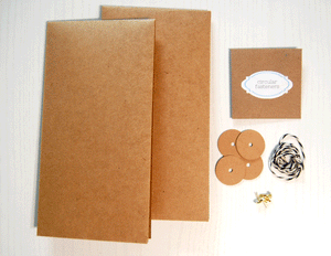 Kraft Envelope with Circular Closures Kit: There are two envelope bases made of brown kraft cardstock; an envelope that has a label that says "circular fasteners"; four kraft circles with holes in them; 4 gold brads; and 26 inches of black and white twine.