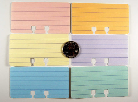 Mini Lined Rolodex Cards in 6 pastel colors: pink, orange, yellow, purple, blue, green. There is a quarter in the center to show size.