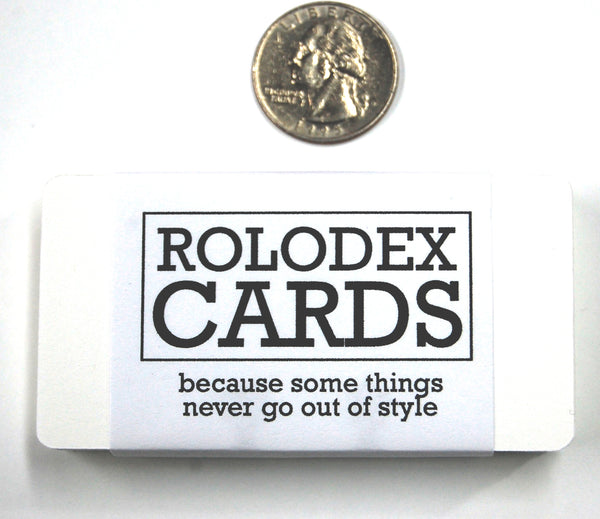 Small White Rolodex Cards wrapped in a wrapper that says "ROLODEX CARDS: because some things never go out of style". There is a quarter for size reference.