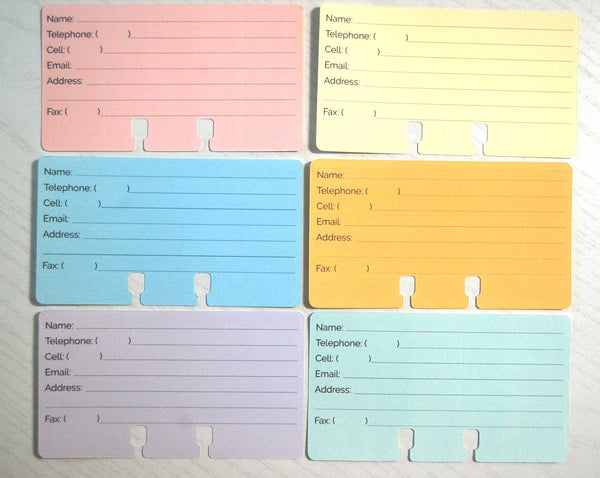 A flat lay overhead view of colorful pastel Rolodex Contact Cards in pink, yellow, blue, orange, purple, and green.