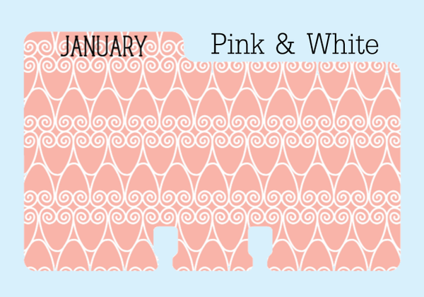 A Calendar Rolodex Divider: The divider is a soft pink with a white swirly pattern. The word "JANUARY" is printed on the tab in black. It is on a pale blue background with the words "Pink & White."