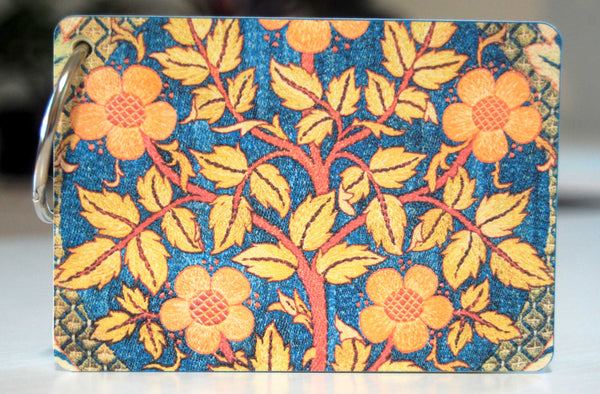 The back of a William Morris fabric print  password keeper in blue, orange and yellow.