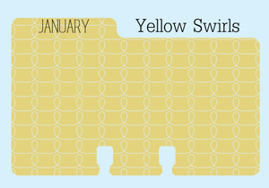A colored Rolodex divider in a yellow print with white swirls. The monthly divider has the word "JANUARY" written in black in all capital letters.  It is on a pale blue background with the word "Yellow Swirls"